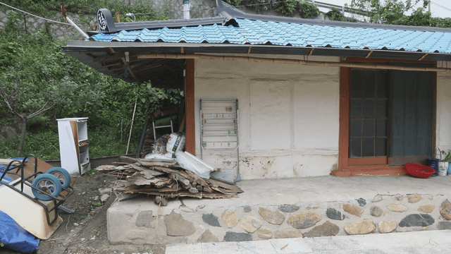 Traditional rural hanok with blue roof