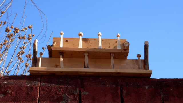 Handcrafted wooden shelves stacked under the clear sky
