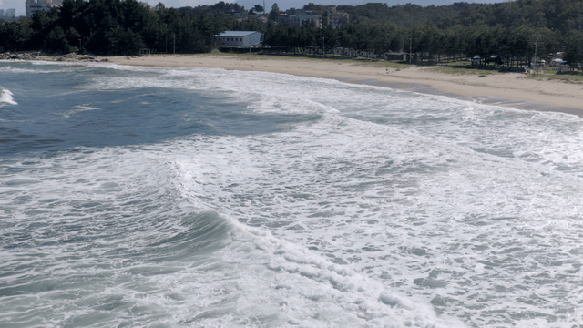 Waves crashing on a sandy beach