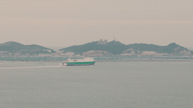 Ferry cruising near a coastal village