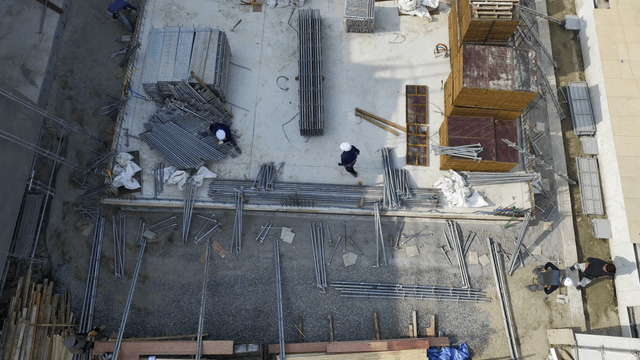 Construction site with workers and materials