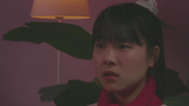 Young sisters locking eyes in a dark room