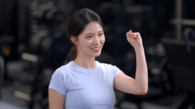 Young woman cheering with a clenched fist in gym