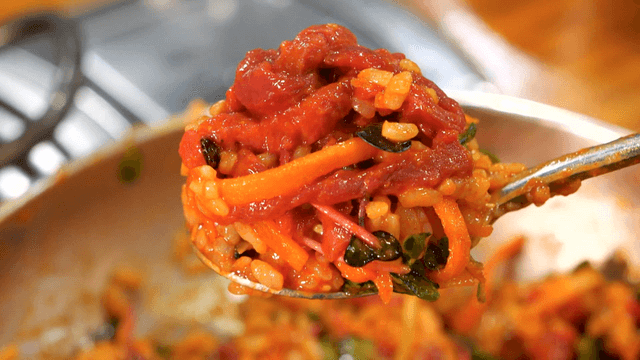 Seasoned yukhoe bibimbap scooped with spoon
