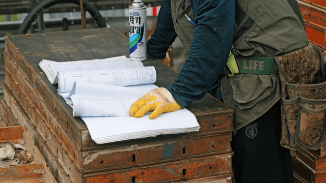 Construction worker reviewing blueprints