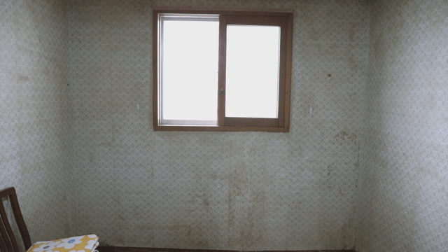 Empty room with a window and chair