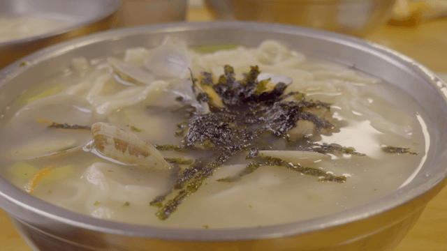 Korean clam noodle soup in a metal bowl