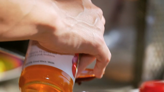 Vinegar being poured into a metal bowl