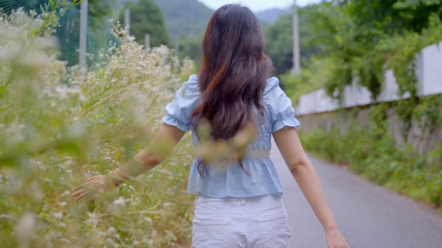 A woman walking along a rural path