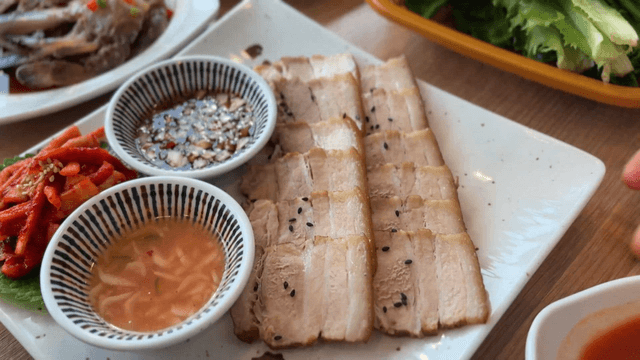 Plate with napa wraps with pork and side dishes