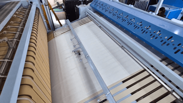 Industrial laundry machine operating in factory