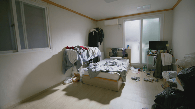 Messy room with clothes and trash scattered