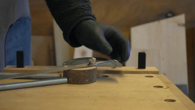 Woodcraft artisan performing precise measurement on wooden block