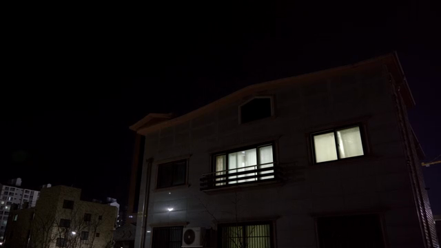 A house with illuminated windows at night