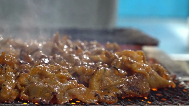 Grilled meat sizzling over open flames