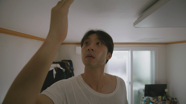 Man looking at his hand after catching a bug