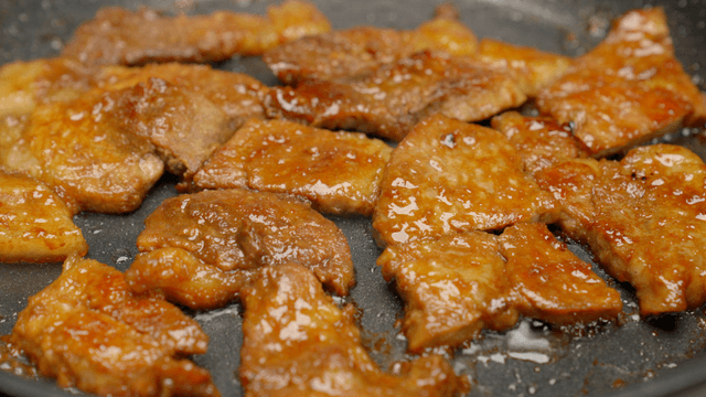 Sizzling marinated pork on a hot pan