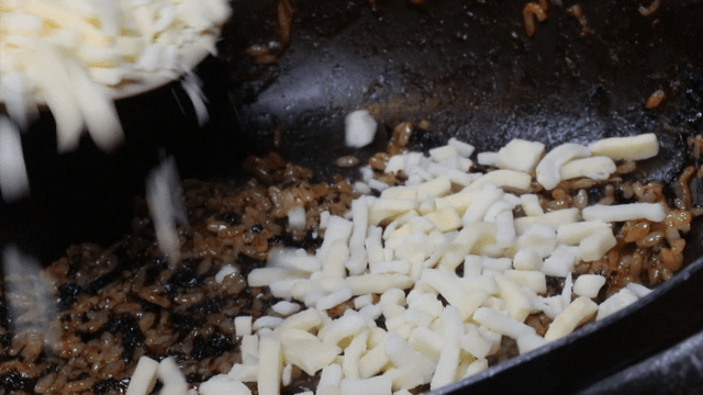 Adding cheese on top of fried rice