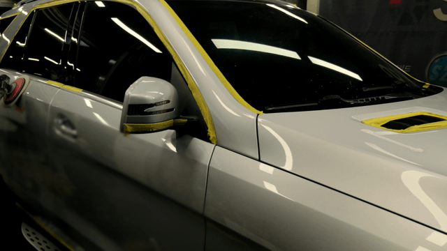 Car door cleaning in a workshop with an electric brush