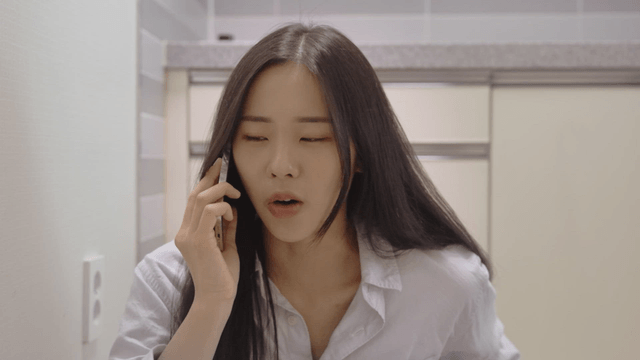 Woman talking on the phone in a house