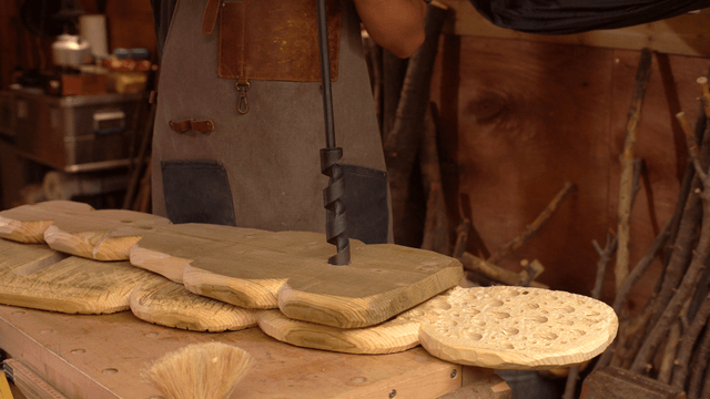 Craftsman working on wooden pieces