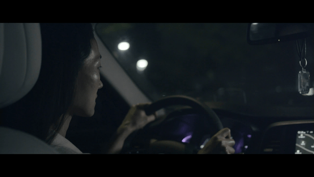 Woman driving at night