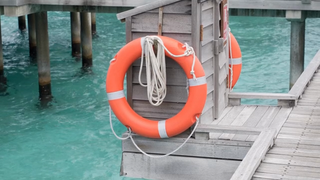 A lifebuoy on a wooden pier by the sea