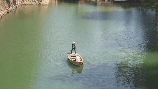 Boatman navigating a calm river