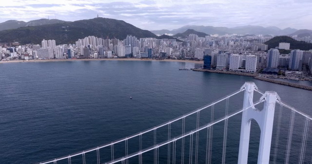 A bridge overlooking a coastal cityscape