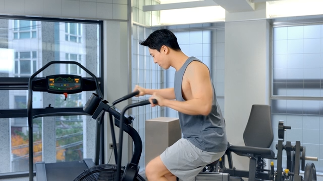 Man exercising on a stationary bike indoors