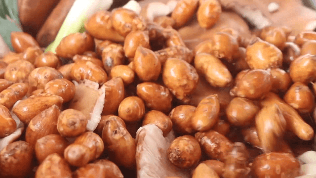 Adding sunchokes to a pot with mushrooms