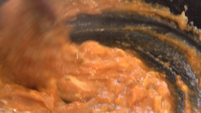 Stirring tomato sauce in a pan