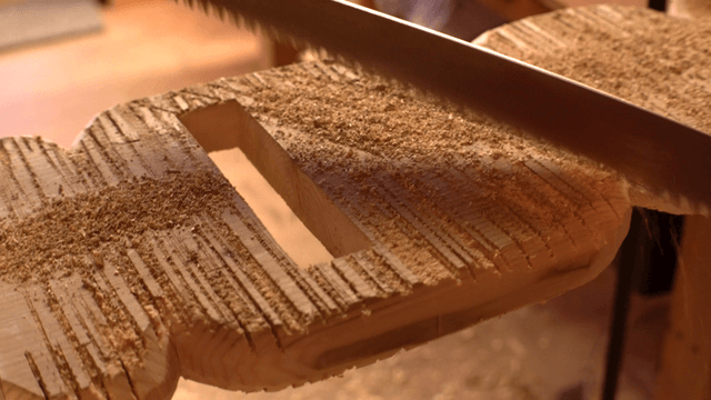 Wood being cut with a saw indoors
