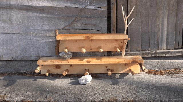 Wooden shelves leaning against a rustic wooden wall