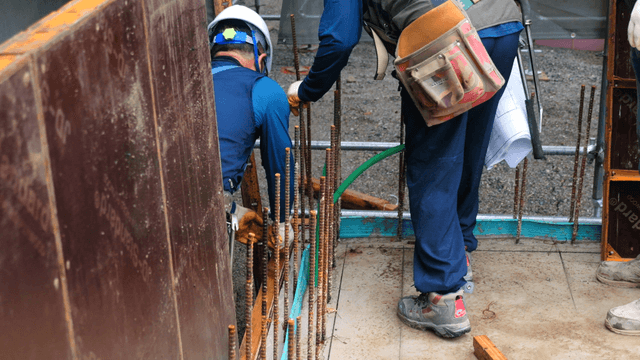Construction workers assembling rebar