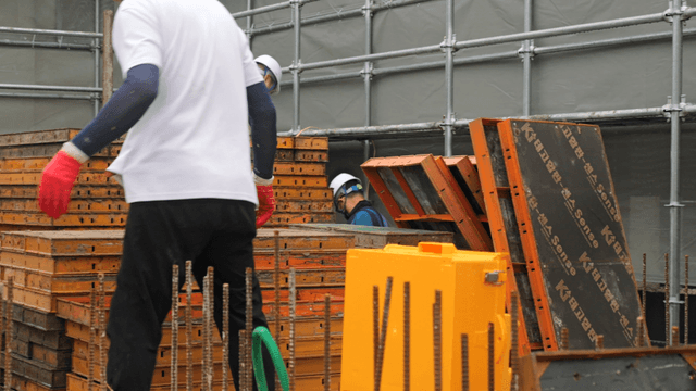 Workers handling materials at a construction site