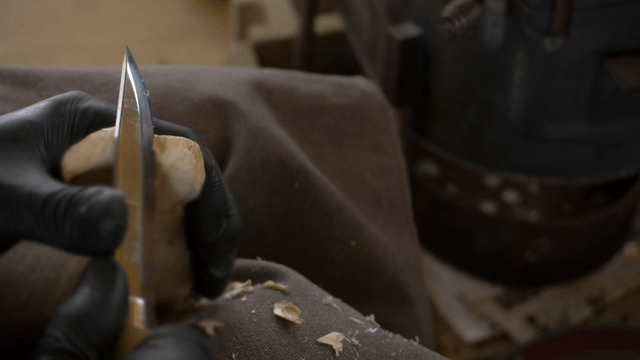 Woodcraft artisan carving a wooden piece with precision