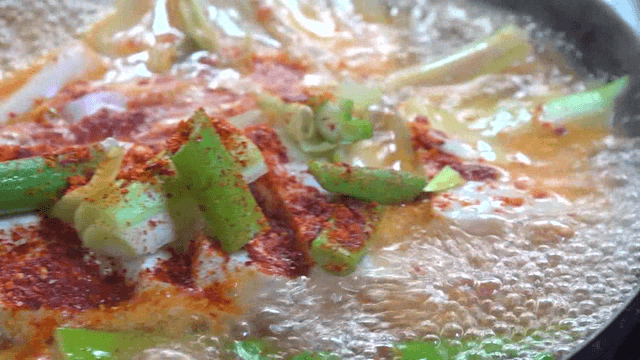 Tofu stew boiling in a pot