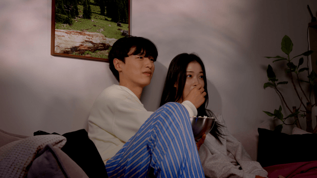 Couple enjoying a cozy movie night at home