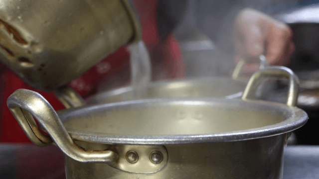 Broth poured into aluminum pots
