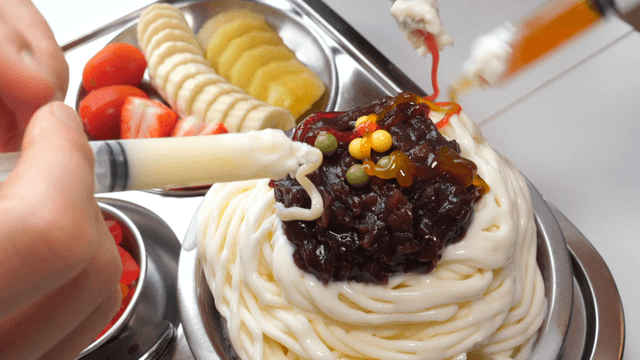 Various syrups poured over shaved ice
