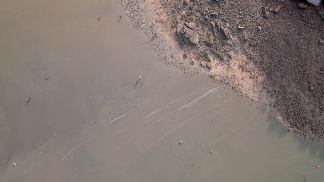 Aerial view of a serene beach with waves