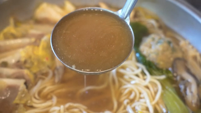Broth from Korean hot pot with noodles and vegetables