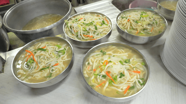 Hand-cut noodle bowls with freshly cooked vegetables
