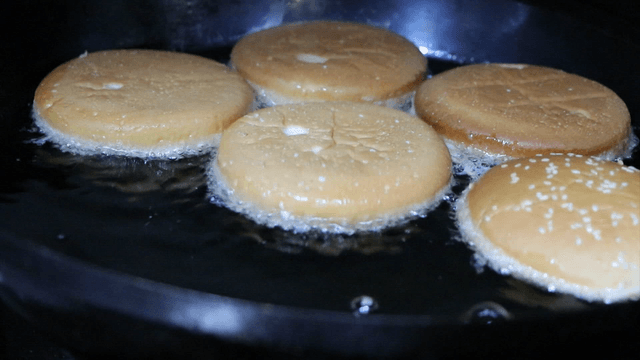 Burger buns frying in a pan