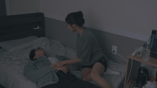 Woman putting a drunk man to bed