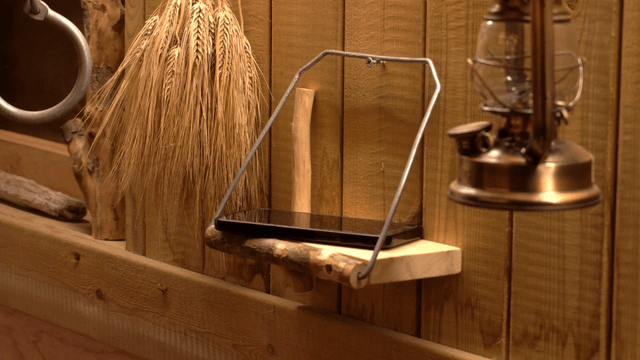 Handcrafted wooden shelf with smartphone and ornaments