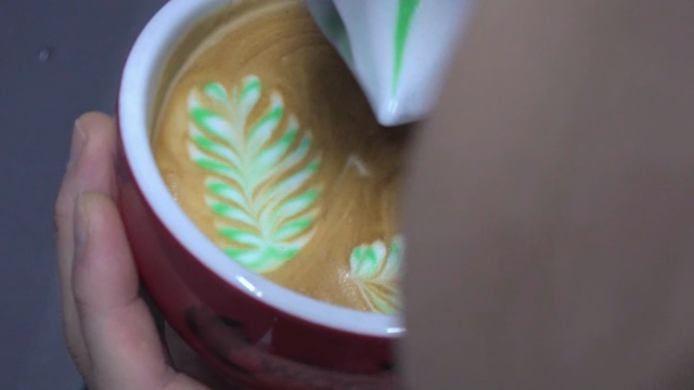 Latte art being created in a coffee cup