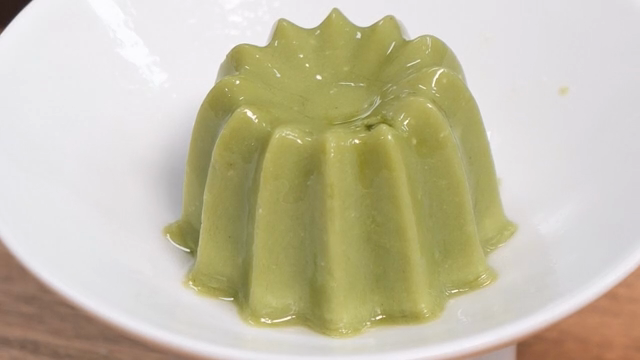 Green pudding in a white bowl