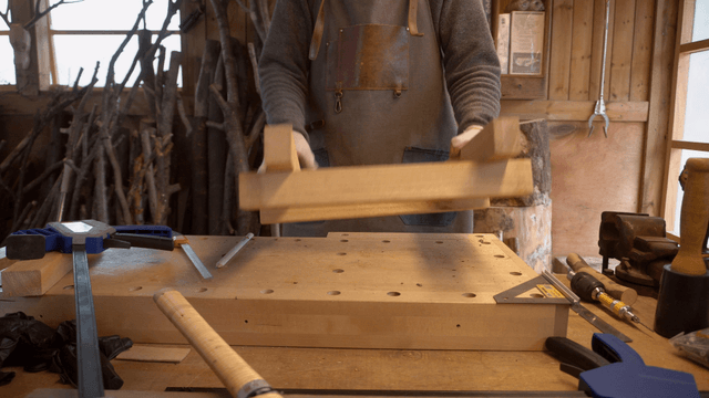 Woodcraft artisan examining connected wooden pieces